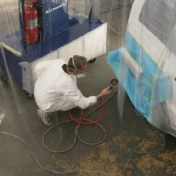 Man Spray Painting in Portable Booth