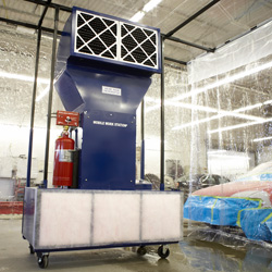 Mobile paint spray booth in auto body shop.