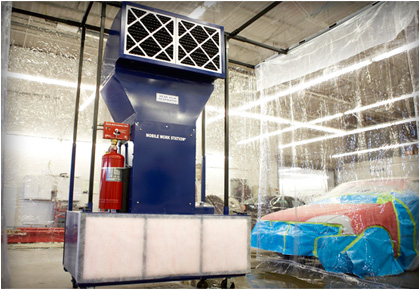 Portable paint booth in body shop.